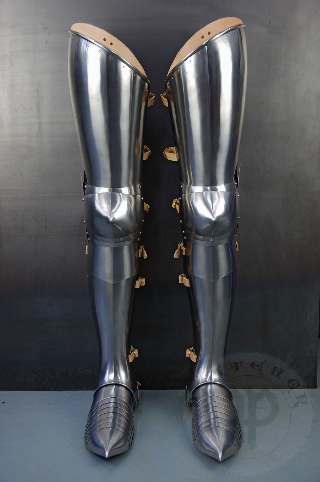 Full leg harness for end of XIV c., begin of XV c. period. Made of medium carbon steel and spring steel from 1,5; 1,2 mm and 1 mm thickness. Poleyns have characteristic pointed shape. Heat hardened and tempered up to 42 HRC. / Pene bigwanty pytowe datowane na koniec XIV wieku i pocztek XV. Wykonane w caoci ze stali redniowglowej i sprynowej o grubociach 1,5 mm; 1,2 mm i 1 mm. Nakolanniki posiadaj charakterystyczny szpiczasty ksztat. Wszystkie elementy hartowane i odpuszczane do 42 HRC. 